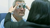 Optician trying frames during eye test