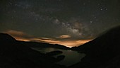 Night sky over lake, timelapse