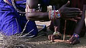 Maasai men making fire, Kenya