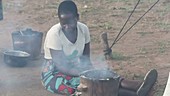 Woman cooking on fuel efficient stove