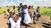 Children using a well pump, Malawi