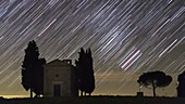 Star trails over Tuscan landscape