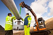 Three wind turbines being constructed