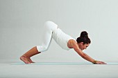 Downward dog – Step 2: bend your knees and lift your head (power yoga)