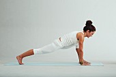 Stretched side angle – Step 2: places hands in front of foot and assume the plank position (power yoga)