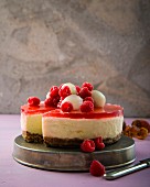 Lychee cheesecake with hibiscus flower jelly and raspberries