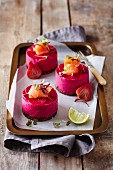 Mini beetroot cheesecakes with salmon and pumpernickel bases