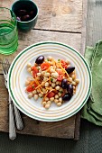 Chickpea salad with carrots, tomatoes and black olives