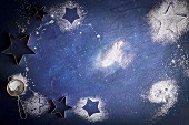 Icing sugar stars on a blue surface