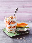 A layered dessert made from papaya, cream cheese and seeds