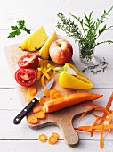 Geschnittenes frisches Obst und Gemüse auf Küchenbrett