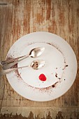 An empty plate with remains of a chocolate cake