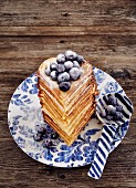 A waffle heart stack with blueberries and icing sugar