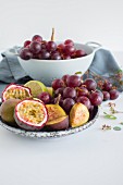 A fruit bowl with grapes, figs and passion fruit