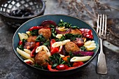 Pasta salad with meat balls, grilled peppers and savoy cabbage