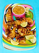 Grilled chicken drumsticks on a colourful plate