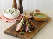 Lamb chops with pesto on an old wooden board