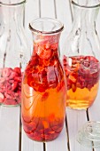 Freeze-dried strawberries and vinegar in preserving bottles