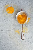 Curry powder in a metal sieve