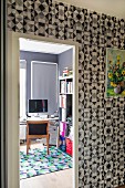 Wallpaper with graphic pattern in hallway and view into study through open door