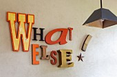 Motto made from various advertisement letters decorating wall