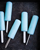 Blue ice lollies on a metal surface