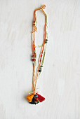 Necklace made from various crocheted cords, wooden beads and tassels