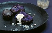 Fried purple potatoes with sour cream