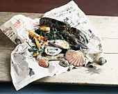 Various types of fresh seafood on a piece of newspaper
