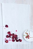 Pitted cherries on a white surface