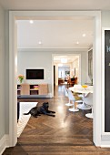 View through open doorway with decorative moulding into living-dining room