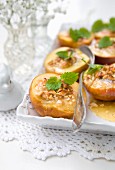 Oven-baked nectarines with honey, nuts and lemon balm