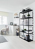 Black metal shelving and armchair in living room