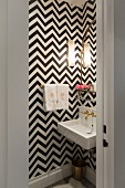 Black and white zigzag wallpaper in small bathroom