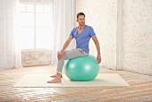 Flexing the spine – Step 1: sit on gym ball and twist upper body to the left