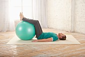 Slanted level – Step 1: lie on back, legs on a gym ball