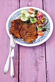 Grilled pork collar steaks with Greek salad