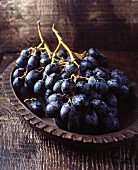 Red grapes in a vintage wooden bowl