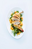 Corn-fed chicken filled with prawns on a bed of rocket with an orange and melon dressing