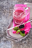 A pink smoothie made with apples, beetroot and banana