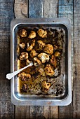 Roasted cauliflower on a baking tray (seen from above)