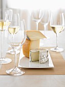 A cheese platter and glasses of white wine
