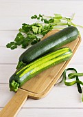 Two courgettes on a wooden board