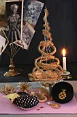 Original Christmas tree made from gold tinsel on cake stand with candle holder