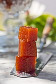 Quince jelly in cubes on an old cake knife