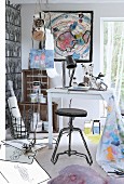Outlines drawn on photo of black stool, white table and various sketches on floor