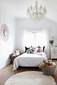 Wood-clad girl's bedroom with collection of soft toys on bed and in wicker baskets