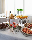 An Easter buffet with pickled salmon, lamb kebabs, avocado and mozzarella cocktails and salt potatoes