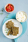 Crackers with dates, chlorella, barley flakes and mixed seeds served with mozzarella and tomatoes