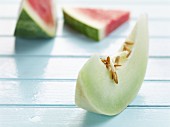 A wedge of honeydew melon and two slices of watermelon